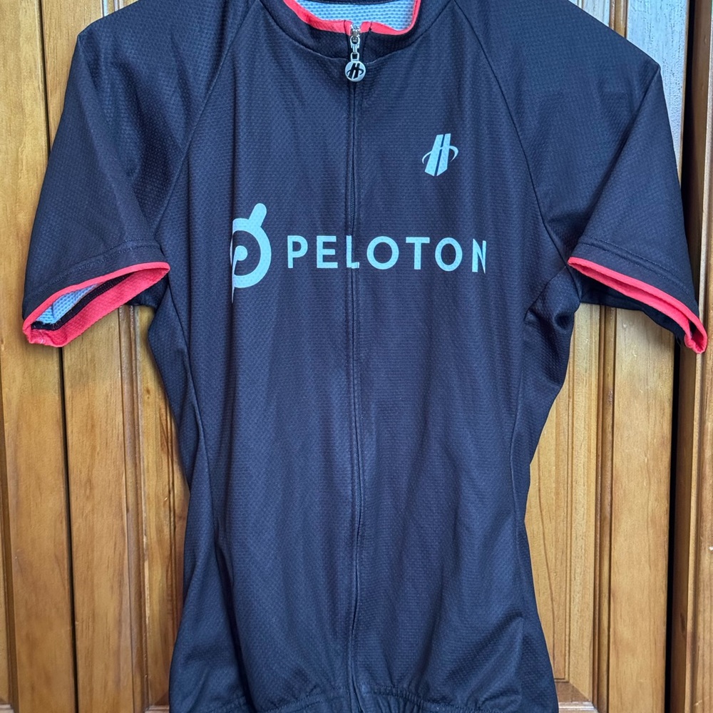 Peloton black cycling bike jersey. Hincapie Sportswear 93% polyester 7% elastan.